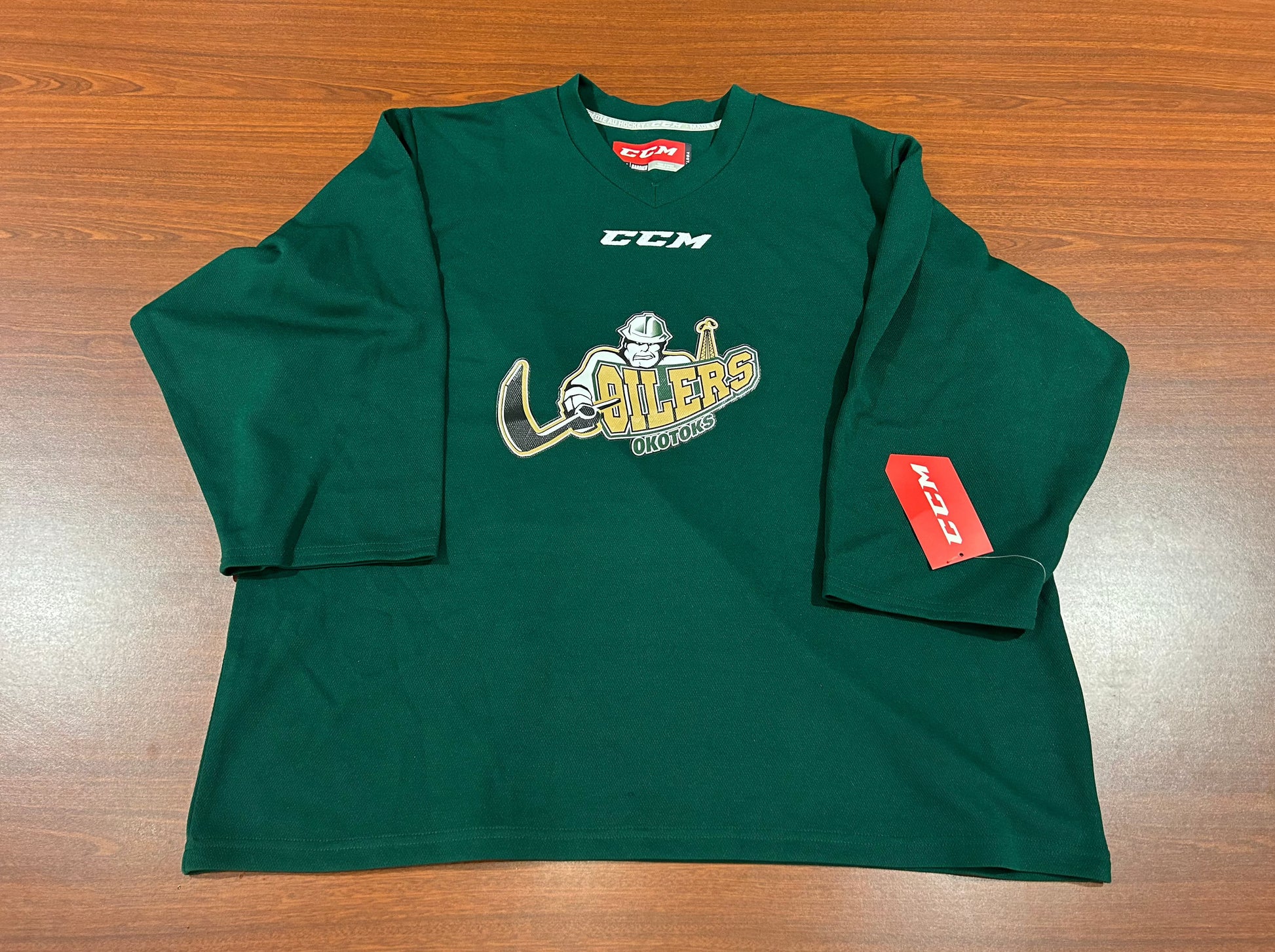 Green jersey with the Oilers' primary logo on the chest underneath the CCM logo.