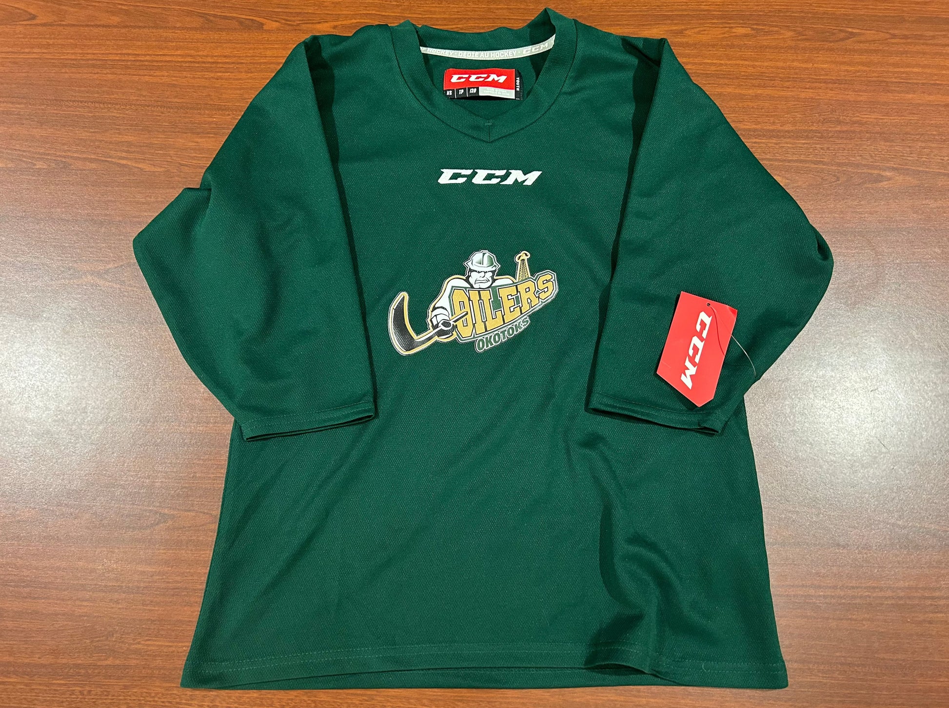 Green jersey with the Oilers' primary logo on the chest underneath the CCM logo.